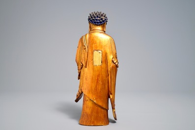 A Chinese carved gilt wood figure of Buddha standing, 18/19th C.