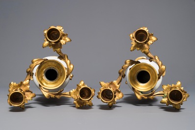 Une paire de vases en porcelaine de Chine famille rose mont&eacute;s comme candelabres, Yongzheng