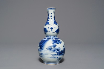 A Chinese blue and white double gourd vase with figures in a landscape, Transitional period