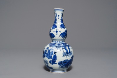 A Chinese blue and white double gourd vase with figures in a landscape, Transitional period