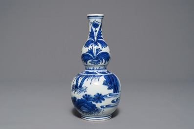 A Chinese blue and white double gourd vase with figures in a landscape, Transitional period