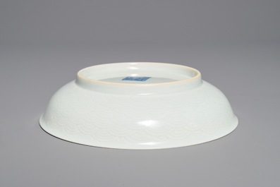A pair of Chinese pale celadon anhua-decorated plates, Qianlong mark, 19/20th C