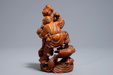 A Chinese carved bamboo group of two playing boys, 19/20th C.