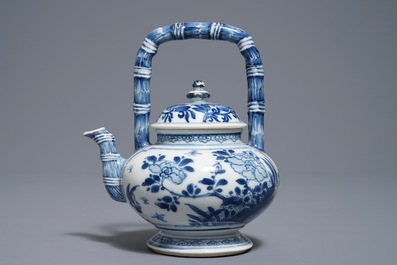 A Chinese blue and white gate-handled teapot and cover, Kangxi
