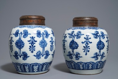 A pair of Chinese blue and white jars and wooden covers, 18/19th C.