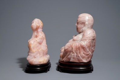 Two large Chinese pink quartz figures on wooden stands, 20th C.