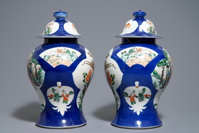 A pair of Chinese famille verte blue ground vases and covers, 19th C.