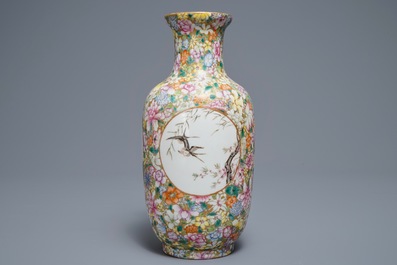 A Chinese famille rose millefleurs vase, Qianlong mark, 20th C.