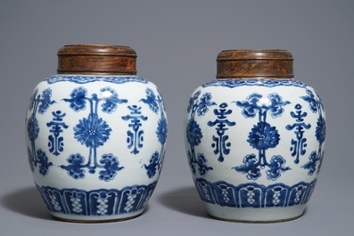 A pair of Chinese blue and white jars and wooden covers, 18/19th C.