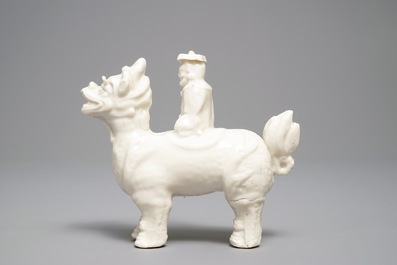 A Chinese Dehua blanc de Chine model of a man on a qilin, Kangxi