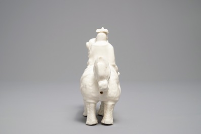A Chinese Dehua blanc de Chine model of a man on a qilin, Kangxi