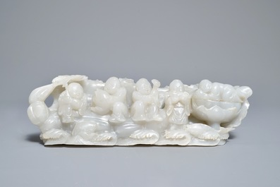A Chinese white jade group with boys on a raft on carved wooden base, Qing