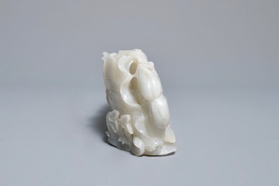 A Chinese white jade group with boys on a raft on carved wooden base, Qing