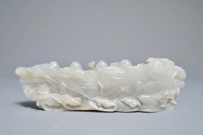 A Chinese white jade group with boys on a raft on carved wooden base, Qing