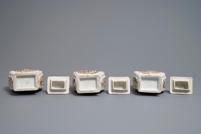 Three Chinese famille rose 'mandarin' vases and covers, Qianlong