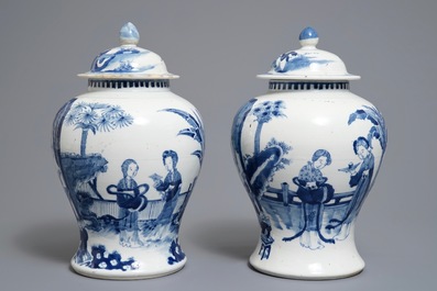 A pair of Chinese blue and white vases and covers, Kangxi mark, 19th C.