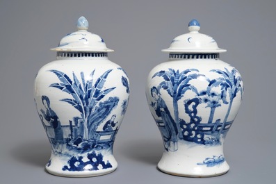 A pair of Chinese blue and white vases and covers, Kangxi mark, 19th C.