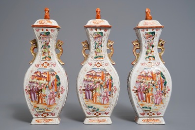 Three Chinese famille rose 'mandarin' vases and covers, Qianlong