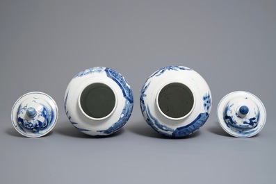 A pair of Chinese blue and white vases and covers, Kangxi mark, 19th C.