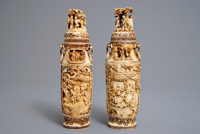 A pair of Chinese ivory vases and covers with figures in landscapes, 1st quarter 20th C.