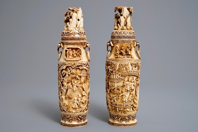 A pair of Chinese ivory vases and covers with figures in landscapes, 1st quarter 20th C.