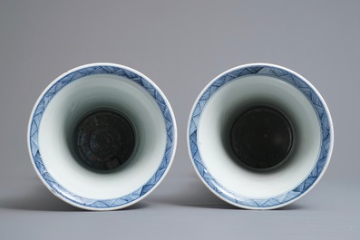 A large Chinese blue and white three-piece garniture with landscape and floral panels, Kangxi