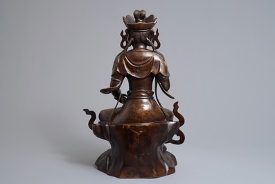 A large Chinese inlaid bronze model of Guanyin on a throne, 19/20th C.