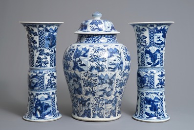 A large Chinese blue and white three-piece garniture with landscape and floral panels, Kangxi