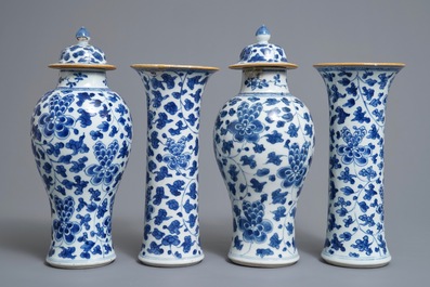 A Chinese blue and white four-piece garniture with floral design, Kangxi