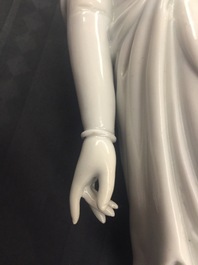 A Chinese Dehua blanc de Chine model of a standing Buddha, impressed mark on the back, Kangxi