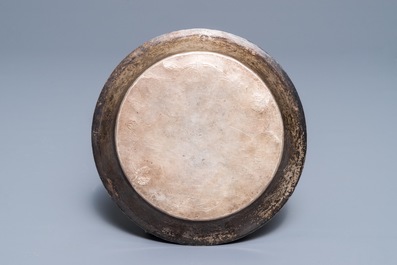 A Sino-Tibetan engraved silver dish with gilt central medallion, 19/20th C.