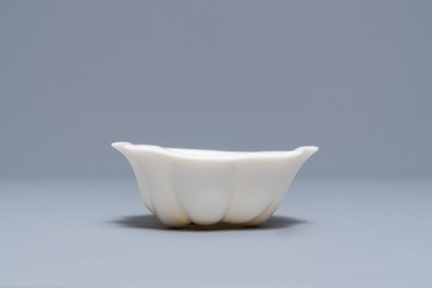 A Chinese Dehua blanc de Chine lotus leaf-shaped brush washer on stand, Kangxi