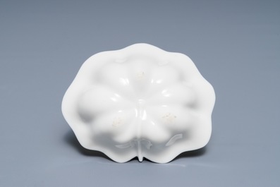 A Chinese Dehua blanc de Chine lotus leaf-shaped brush washer on stand, Kangxi
