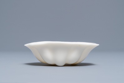 A Chinese Dehua blanc de Chine lotus leaf-shaped brush washer on stand, Kangxi