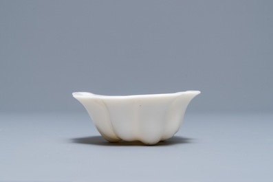 A Chinese Dehua blanc de Chine lotus leaf-shaped brush washer on stand, Kangxi