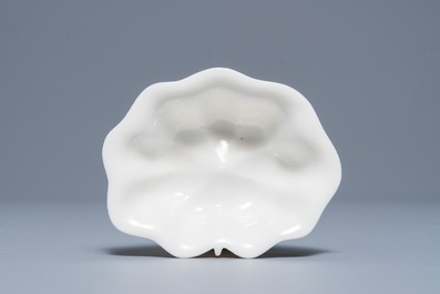 A Chinese Dehua blanc de Chine lotus leaf-shaped brush washer on stand, Kangxi