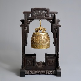 A Chinese gilt bronze bell in zitan suspension frame, Qianlong mark, 18/19th C.