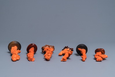 Six Chinese carved coral figures on wooden stands, 19/20th C.