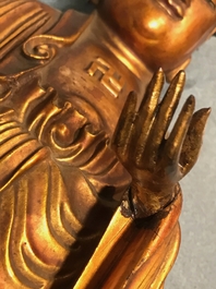 A Chinese carved gilt wood figure of Buddha standing, 18/19th C.