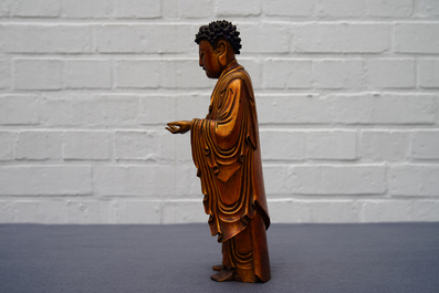 A Chinese carved gilt wood figure of Buddha standing, 18/19th C.