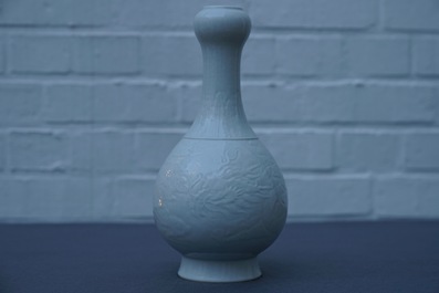 A Chinese blanc de Chine vase with underglaze dragon design, Qianlong mark, 19/20th C.