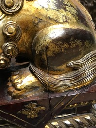 A pair of Chinese gilt-laquered wood Buddhist lions, 19th C.