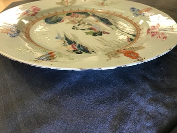 A Chinese famille rose "Eight Immortals" charger with a central landscape, Qianlong