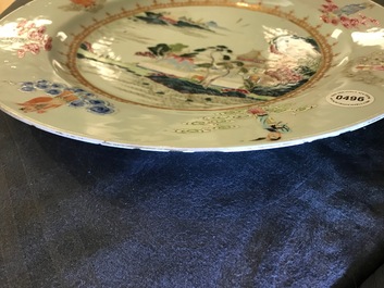 A Chinese famille rose "Eight Immortals" charger with a central landscape, Qianlong