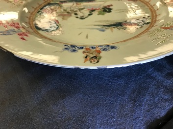 A Chinese famille rose "Eight Immortals" charger with a central landscape, Qianlong