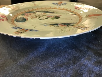 A Chinese famille rose "Eight Immortals" charger with a central landscape, Qianlong