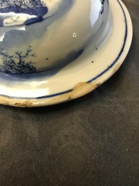 A pair of Chinese blue and white vases and covers, Kangxi mark, 19th C.