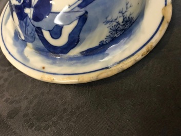 A pair of Chinese blue and white vases and covers, Kangxi mark, 19th C.