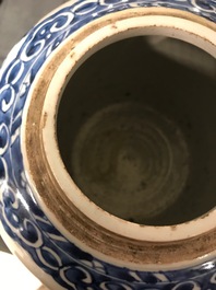 A pair of Chinese blue and white jars and wooden covers, 18/19th C.