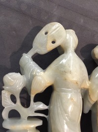 A Chinese jade group of two ladies and two reticulated buttons, 19/20th C.